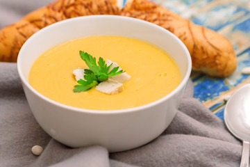 healthy soup at plate on a blue wooden table