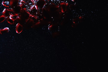 Water drops on ripe sweet pomegranate seeds. Fresh pomegranate background with copy space for your text. Vegan concept.