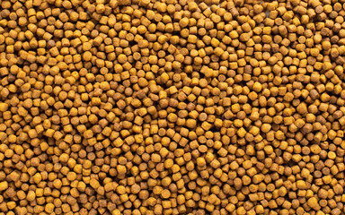 Above or Top view of animal food. Brown Dried dog food on white background. Grain pet food banner background with copy space for text design.