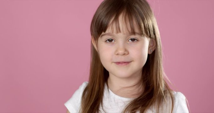 Young beautiful happy and excited blond girl 6 or 7 years old holding donut on her eyes