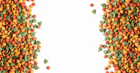 Fototapeta premium Above or Top view. Colourful Dried dog food on white background. Grain pet food banner background with copy space for text design.
