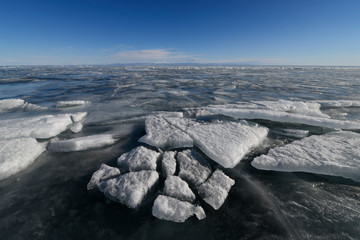 Ice floes and water on the shore of Lake Baikal