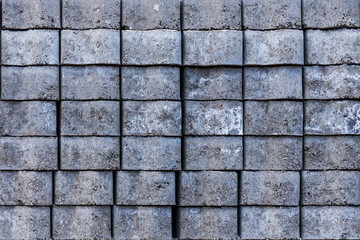 grey textured background, curb stone laid on a pallet