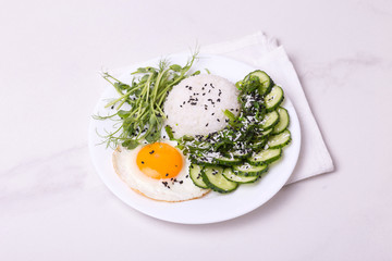 Rice with cucumber, scrambled eggs, microgreen and Japanese wakame seaweed salad.