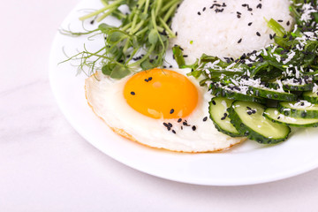 Rice with cucumber, scrambled eggs, microgreen and Japanese wakame seaweed salad.