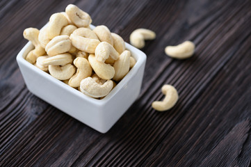 Full Raw Cashew Nuts in white ceramic bowl