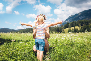 happy young woman with little girl in field