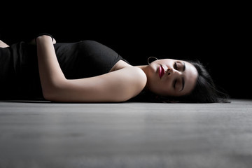 Fototapeta na wymiar Portrait of young woman lying down on a floor