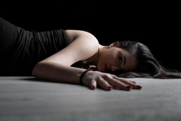 Portrait of young woman lying down on a floor