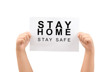 Kid's hands holding Stay home, stay safe message on paper isolated