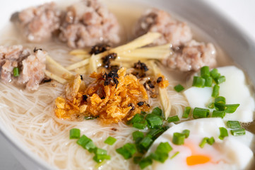 Thai style clear soup rice noodle in traditional bowl. Selective focus