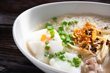 Thai style clear soup rice noodle in traditional bowl. Selective focus