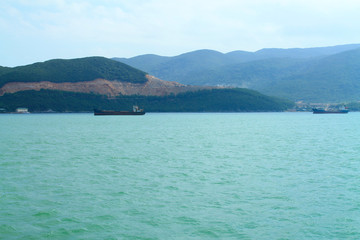 A scenic view of the mountain islands and boats near the city of Nha Trang. Turquoise Sea in Vietnam