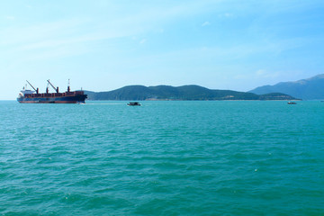 Obraz premium A scenic view of the mountain islands and boats near the city of Nha Trang. Turquoise Sea in Vietnam
