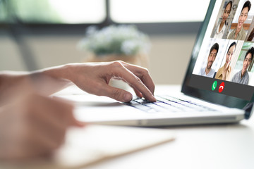Female girl hands on computer laptop operating remote meeting conference program. Woman writing some short note on paper after discuss with office team colleague at home. Prevent for covid19 outbreak.