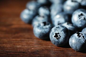 Water drops on ripe sweet blueberry. Fresh blueberries background with copy space for your text. Vegan and vegetarian concept. Macro texture of blueberry berries.