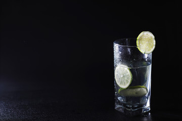 Lime water. Drinking water with fresh lime. Mineral water. Healthy, mineral-rich, refreshing water with lime.