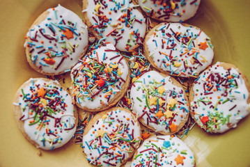 texture, background, baking cream dessert sweet, happy easter. glaze. multi-colored topping, cookies on a plate