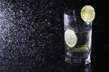 Fototapeta na wymiar Lime water. Drinking water with fresh lime. Mineral water. Healthy, mineral-rich, refreshing water with lime.