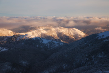 Winter mountains landscape at dawn in the morning and beautiful low clouds