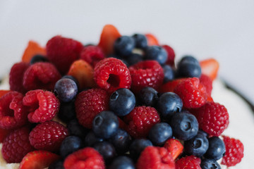 Tasty summer berry baiser pavlova cake with strawberries, raspberries and blueberries