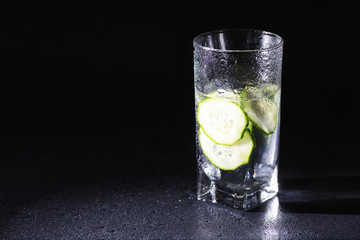Cucumber water. Drinking water with fresh cucumber. Mineral water. Healthy, mineral-rich, refreshing water with cucumber.