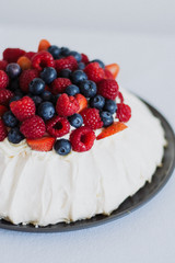 Tasty summer berry baiser pavlova cake with strawberries, raspberries and blueberries