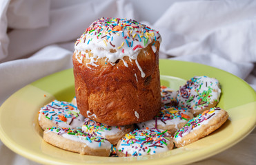 Easter cake, texture, background, baking cream dessert, sweet, happy easter dessert. glaze. multi-colored topping, cookies on a plate