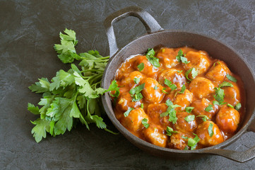 Meatballs in sweet and sour tomato sauce with spices.