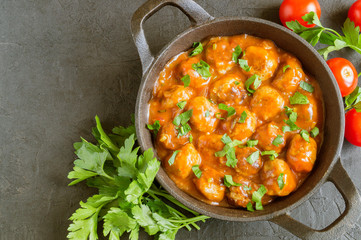 Meatballs in sweet and sour tomato sauce with spices.