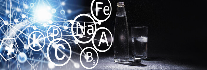 Obraz premium Close up pouring purified fresh drink water from the bottle on table in living room. Drinking water. Mineral vitamin water. Healthy, mineral-rich, refreshing water.