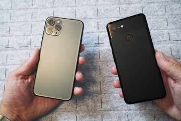 Comparison of two mobile phones. Old phone with one-lens and newest smart phones with triple-lens...