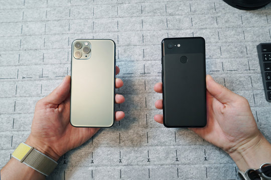 Comparison Of Two Mobile Phones. Old Phone With One-lens And Newest Smart Phones With Triple-lens Camera