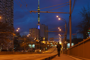 Moscow cityscape in night. Illuminated street. Almost no people. Free way. No traffic. Ostankino TV Tower. Coronavirus pandemic. Concepts - stay home, save  live.