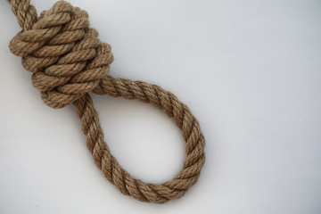Braided thick rope tied in a skein. Hemp rope for decoration and design. Background from a fishing rope.