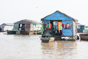 Fototapeta na wymiar Floating Village on TonleSap Lake in Cambodia. Houses on the water