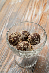 Rum balls of sponge biscuit, cocoa, rum and almonds in a glass bowl