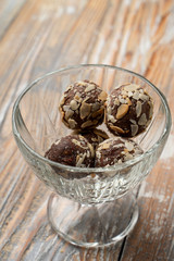 Rum balls of sponge biscuit, cocoa, rum and almonds in a glass bowl