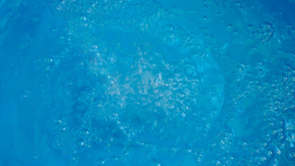 Abstract wallpaper with water surface with bubbles on blue background.