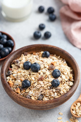 Bowl of oat muesli with nuts, dried fruit and blueberries. Healthy breakfast food, clean eating and dieting concept. Breakfast cereals