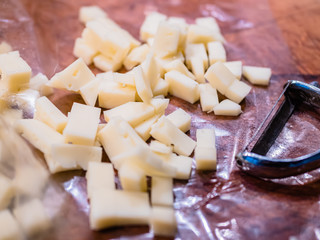 Close-up of the typical cheeses used in the recipe for making Pizzoccheri. Typical dish from Valtellina, Lombardy, Italy.