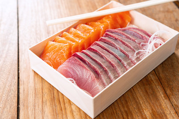 Salmon and Tuna sashimi cutting fresh and raw in Japanese style. on wooden table background, Healthy Eating and Eat Well Concept. Take away home food. Close up
