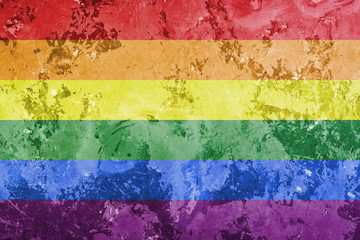 gay rainbow flag on concrete background as lgbt symbol.