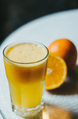 Orange juice and slices of orange fruit in glass