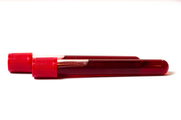 Two test tubes with blood isolate on a white background. The concept of medicine, the fight against viruses and bacteria, diseases