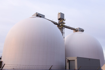 Two round toped white grain silos in the Foulon Cove port area seen from the Champlain Boulevard...