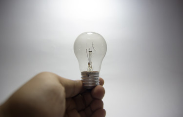 Hand of holding illuminated light bulb, innovation inspiration concept ,business idea