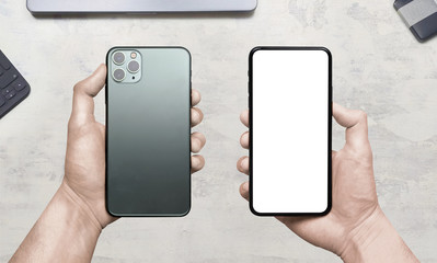 Man holds new midnight green smartphone with triple-lens camera. Back and front view