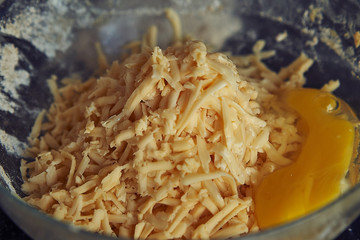 delicious grated cheese in a glass bowl with an egg
