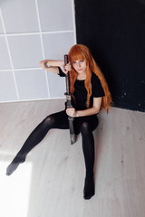woman anime cosplayer with red hair Japanese sword